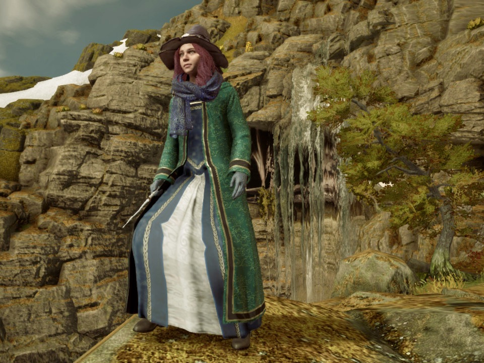 A brown-haired girl named Emily wearing a black leather witch hat, a green robe, and a blue dress in the world of Hogwarts Legacy.